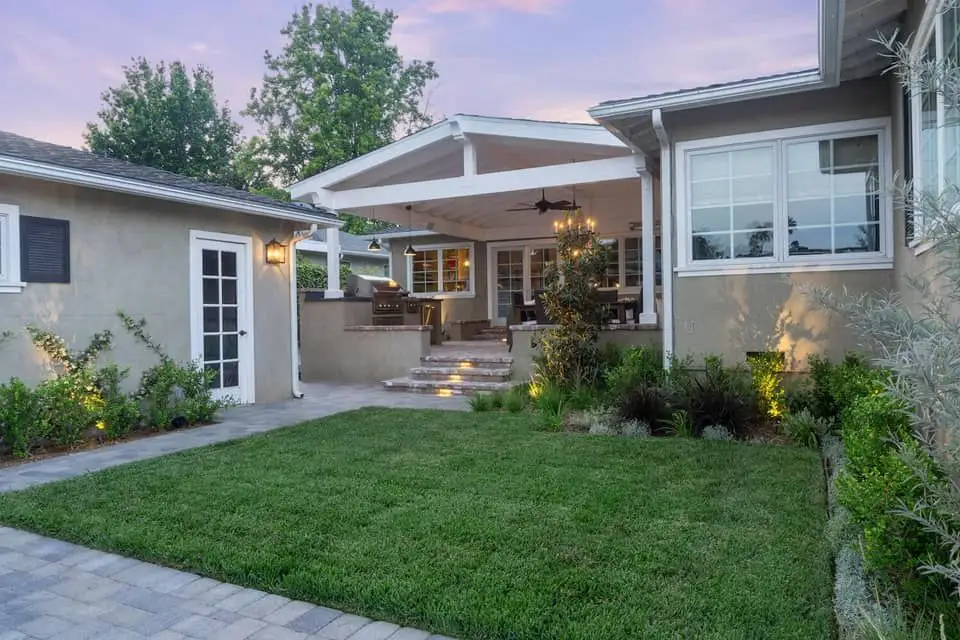New turf and garden beds freshly installed at a modern home front yard