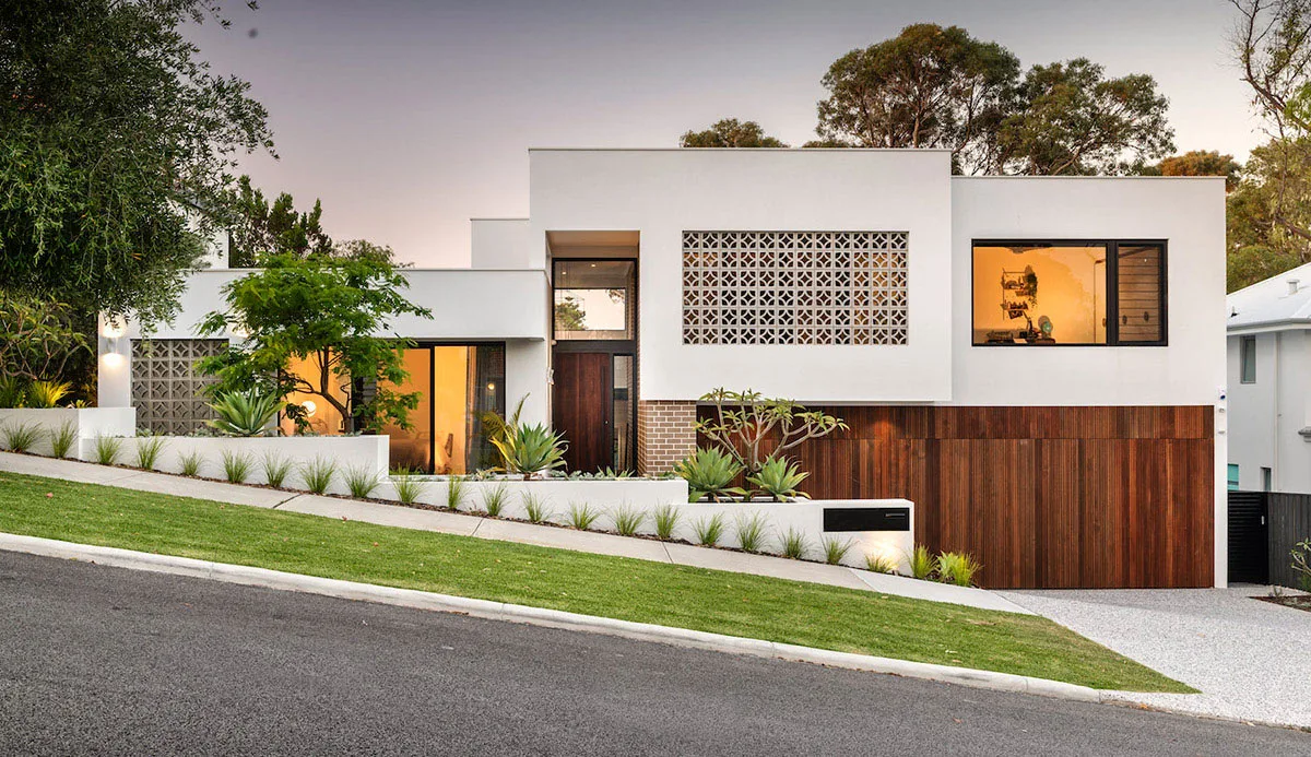 Modern home with a breeze-block feature screen and gravel driveway