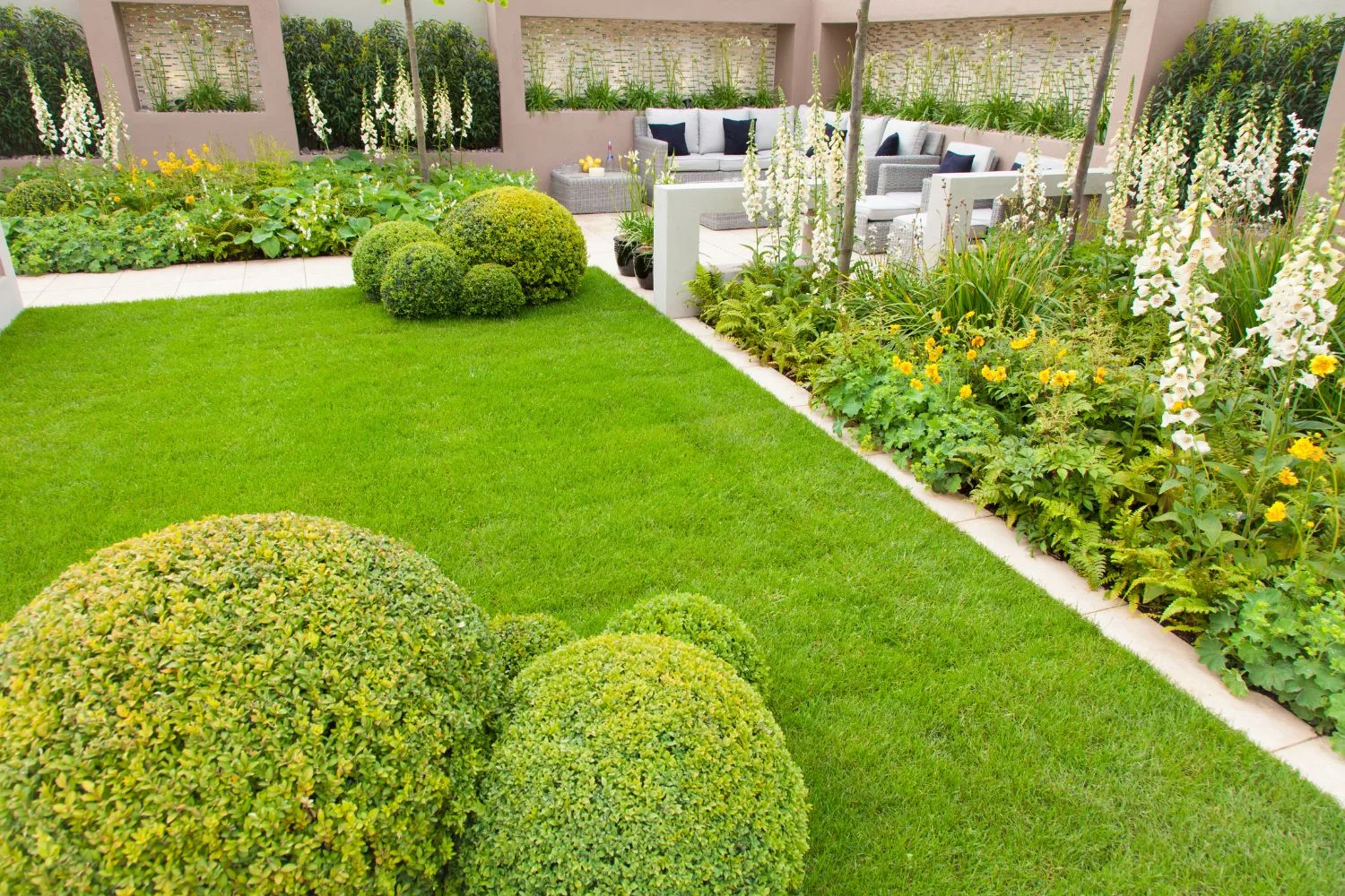 Manicured formal garden with clipped hedges and lawn