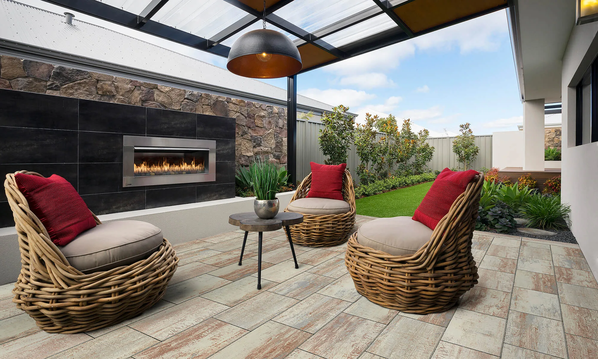 Outdoor lounge with a built-in stone fireplace